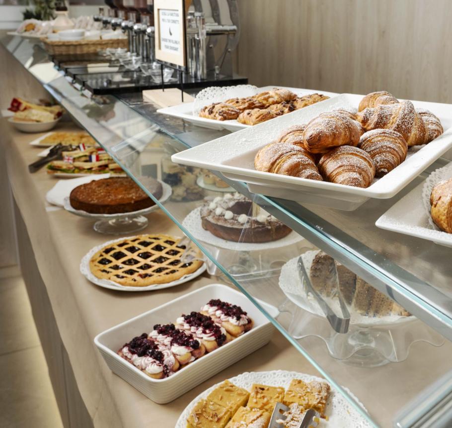 Delicious pastries with croissants and cakes, aroma of sweetness and warmth.
